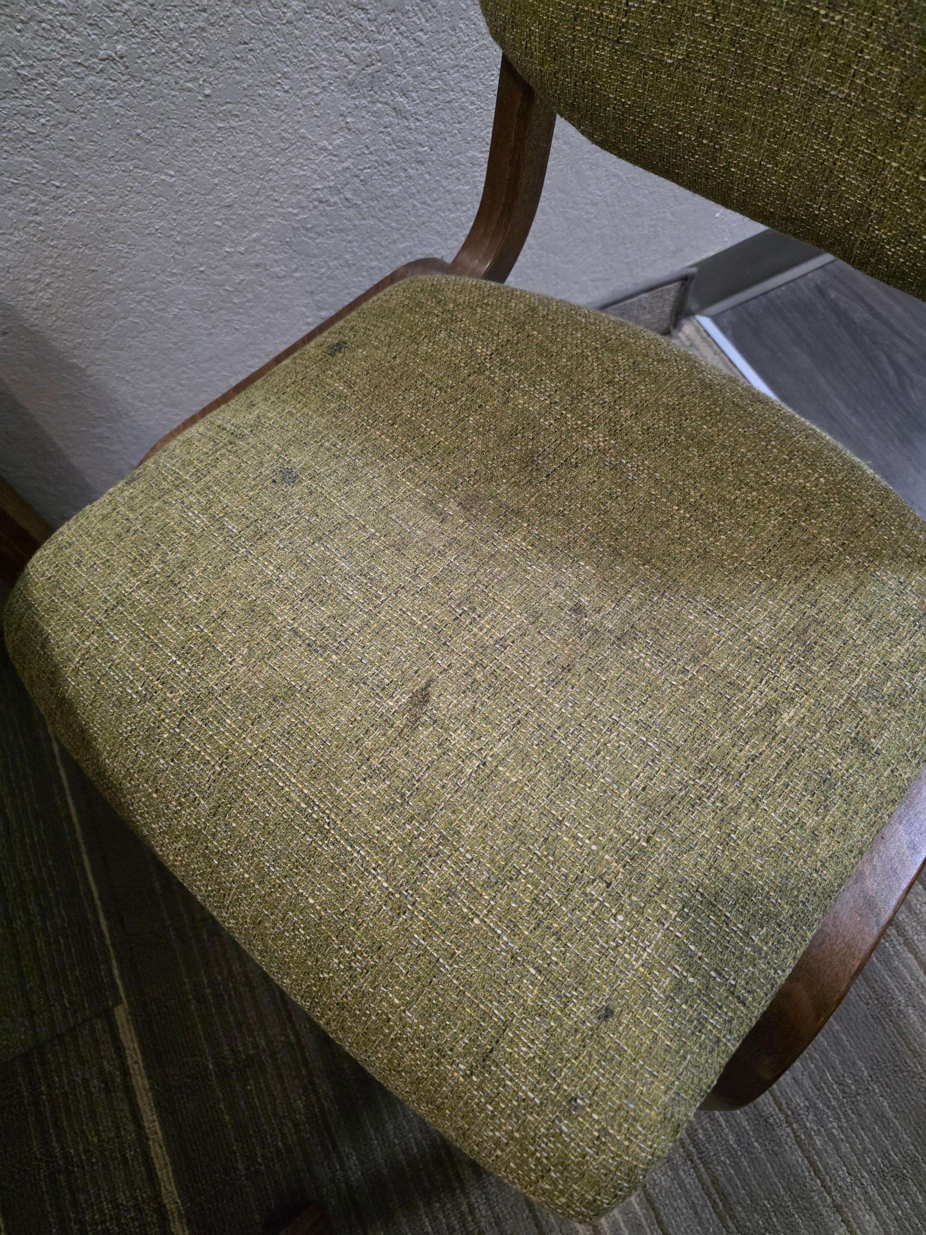 Filthy stained chairs at table. 