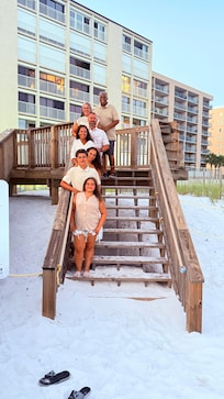 Family pic on stairs  up to the condo.
They’re is also a ramp for wagons.