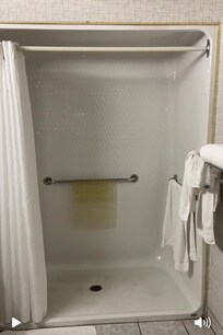 Shower has a lip at the bottom, although wide. Not really wheelchair friendly.