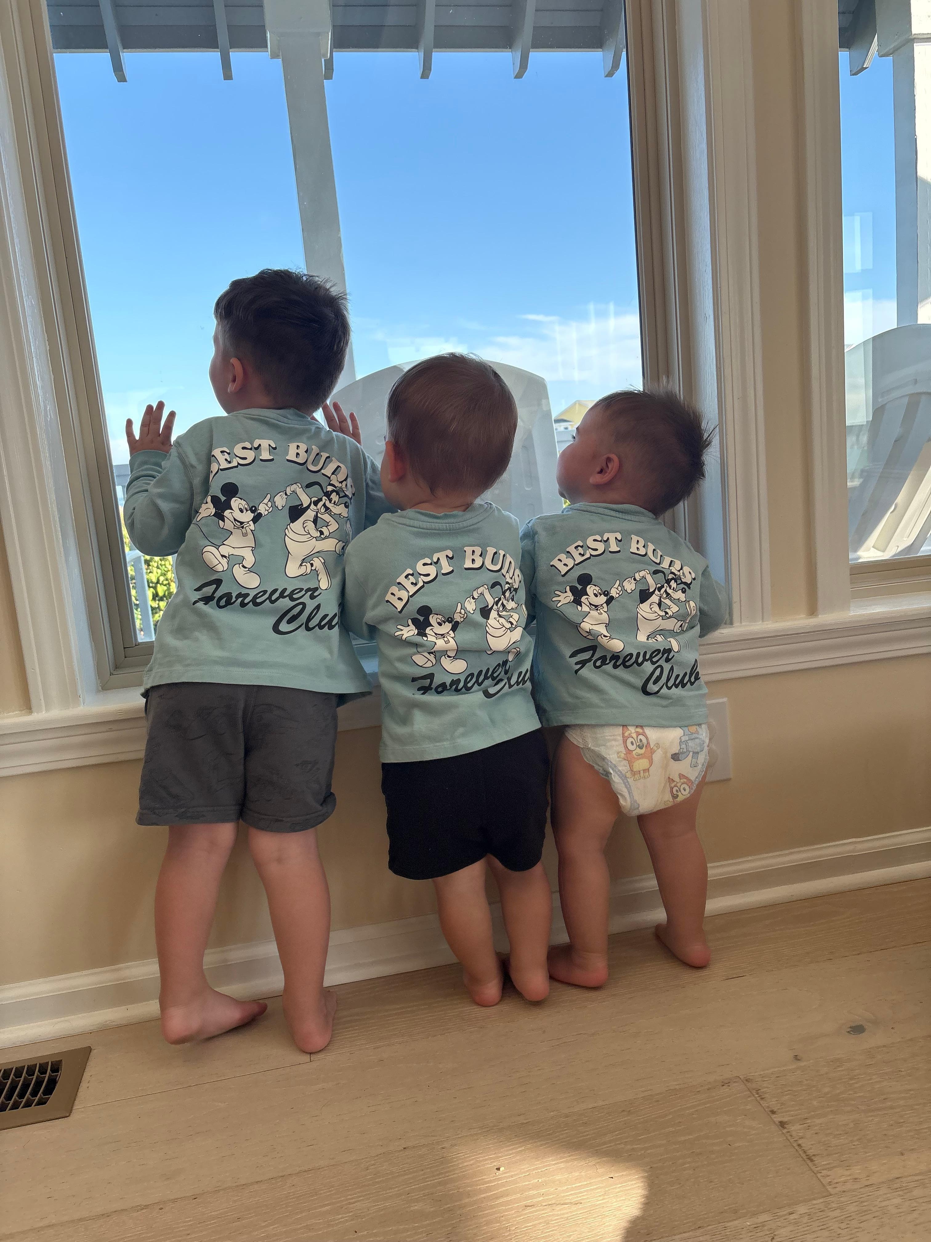 The Grands looking out the front window onto the front porch for the little frog who lives on the back of one of the rocking chairs 