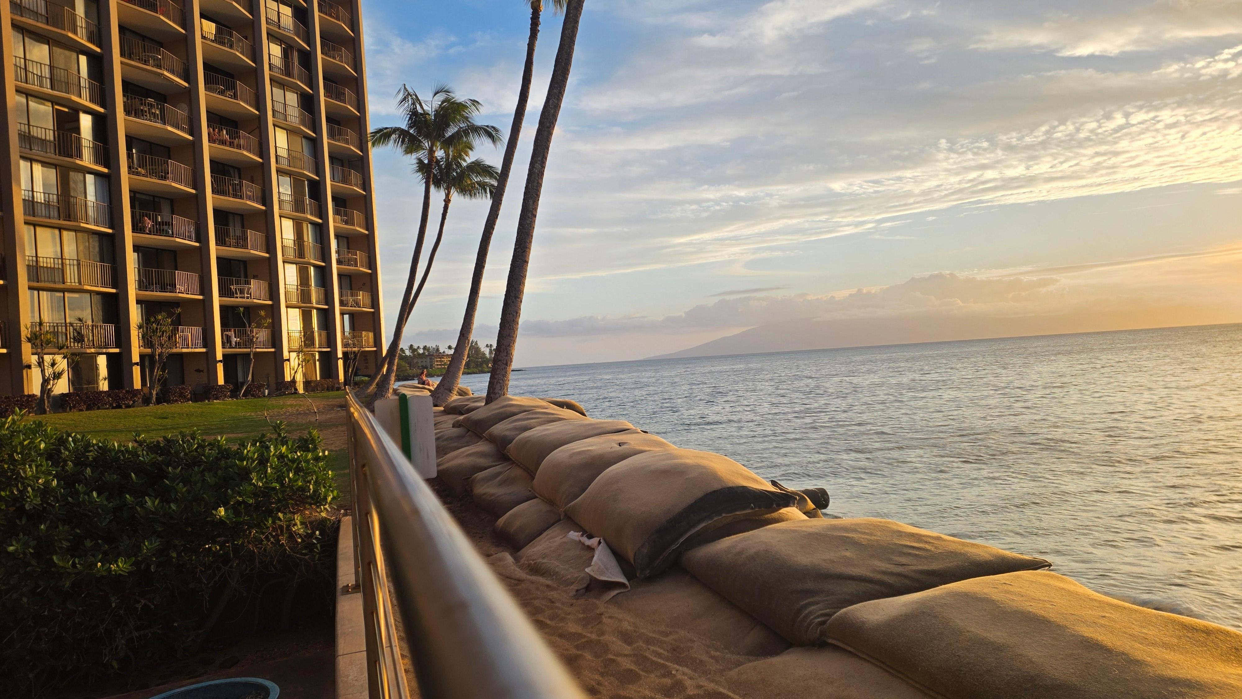 The sandbags / breakwater is right in front of the pool deck.  There is no beach access from the property