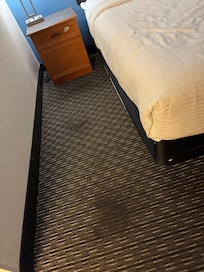 Throughout the whole room, the carpets are stained