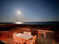 View of beach from back deck at night
