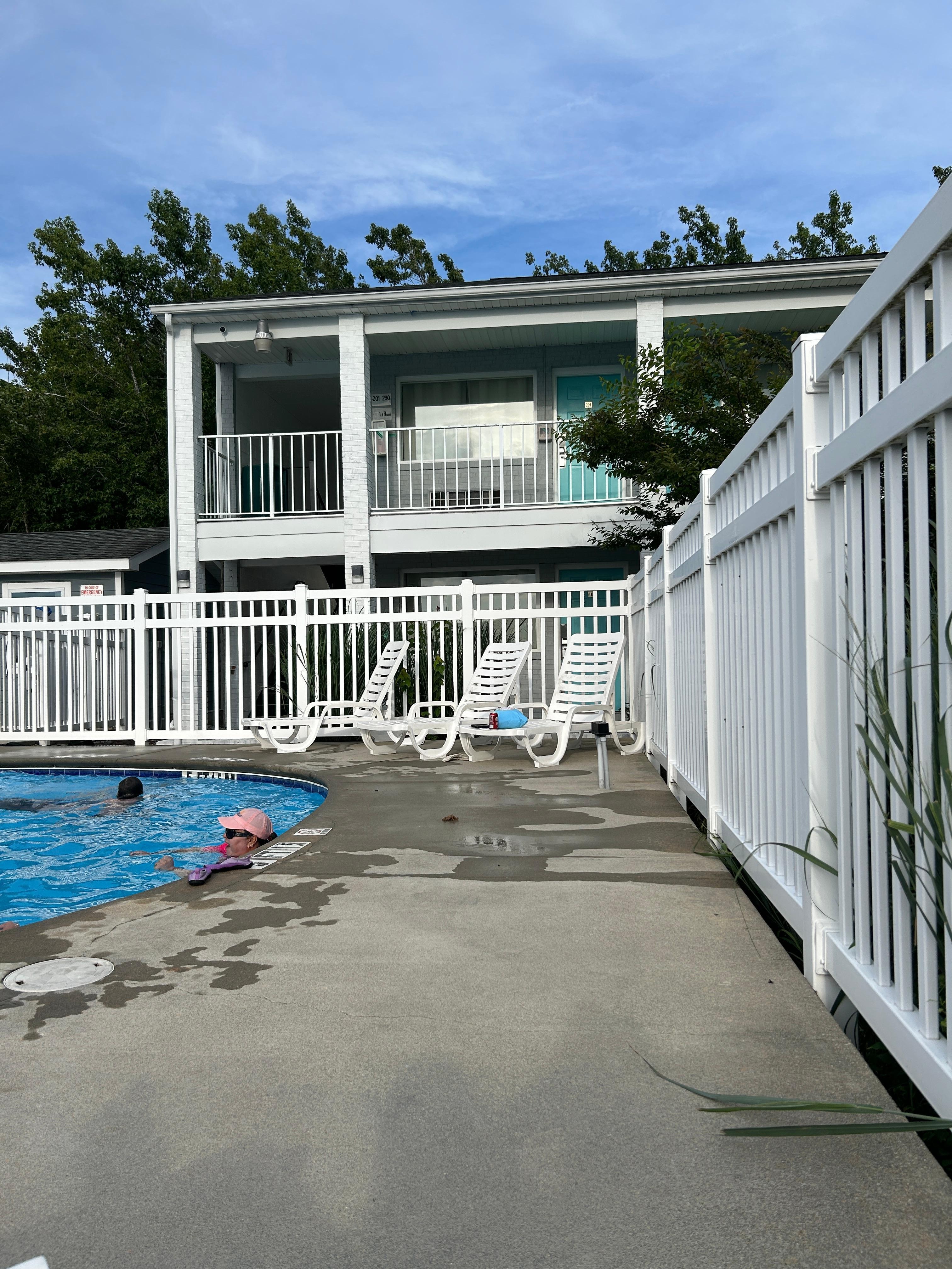 Hotel in background was next door. I’m guessing the pool belongs to that hotel since the gate was on their side and their patrons were also using the pool and the gate was on their side. Plus that hotel personnel was testing the pool and hot tub.