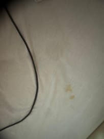 Stains on sheet from the first night. I don’t know how they could not see these stains when making a bed.