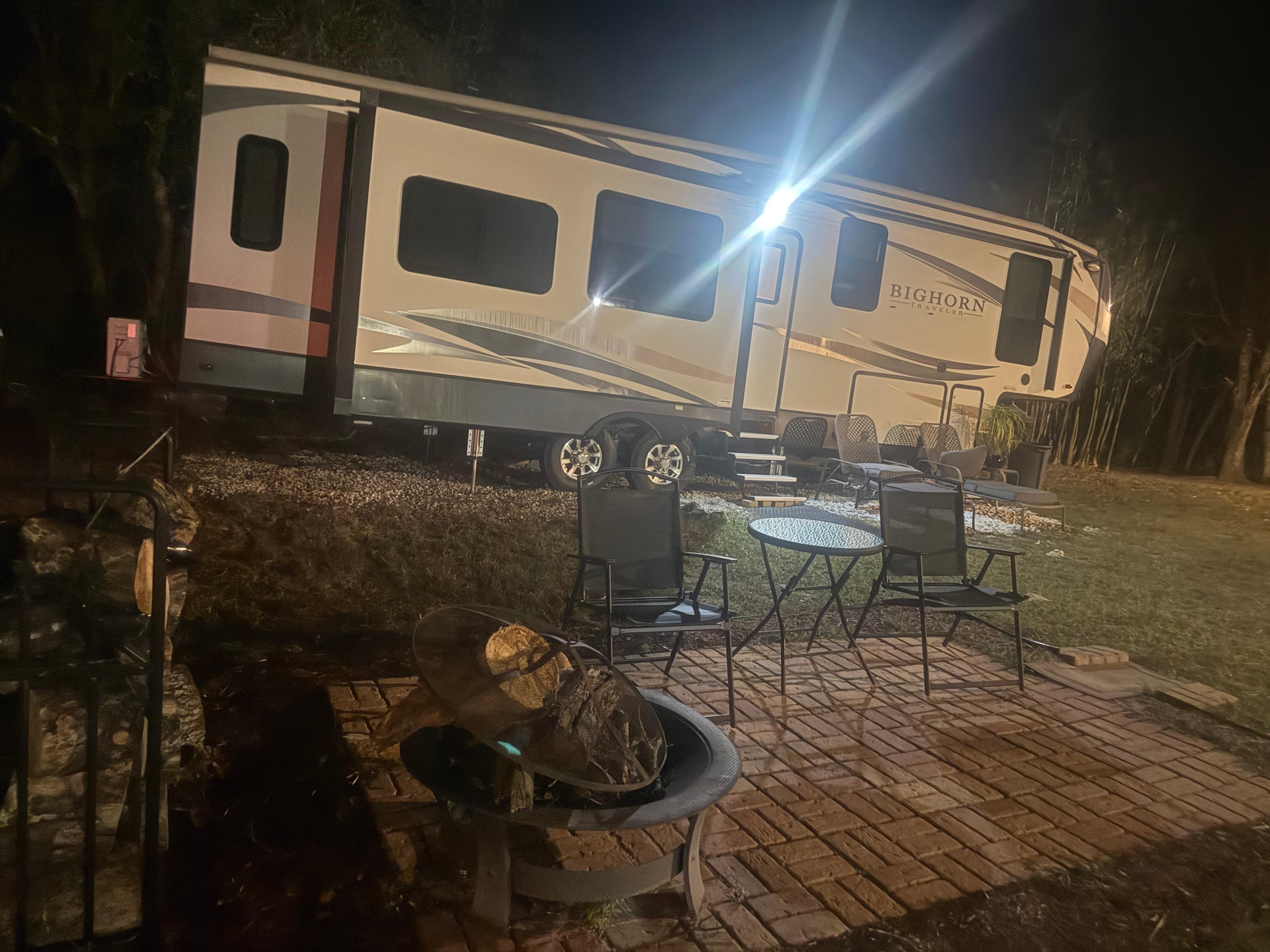 Outside seating area and firepit with firewood ready to use. 