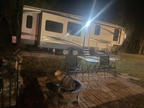Outside seating area and firepit with firewood ready to use.