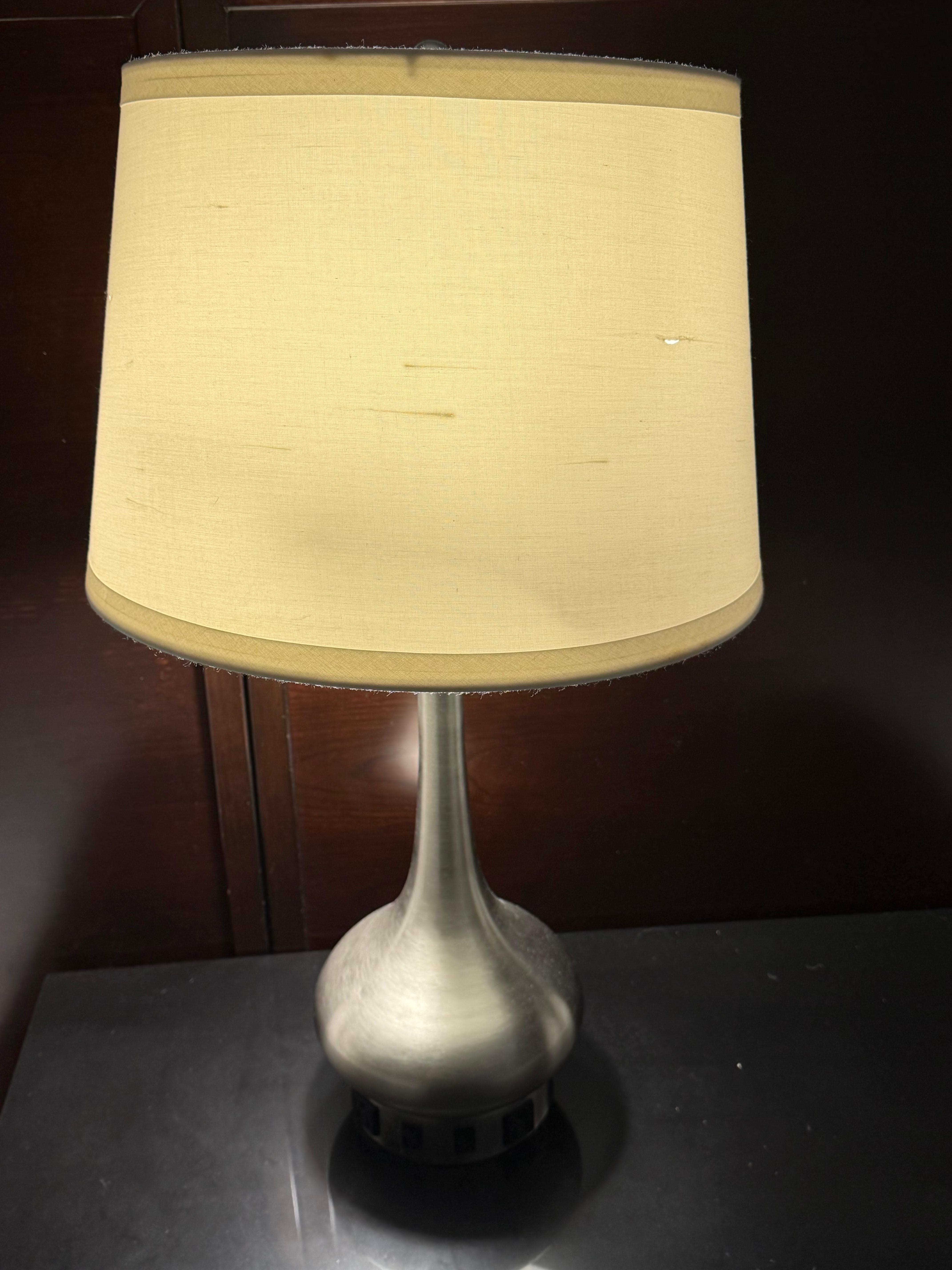 Lamp look beat up, holes in it and slanted.