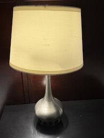 Lamp look beat up, holes in it and slanted.