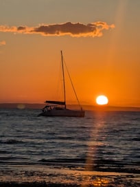 Sunset on the beach next to the jetty