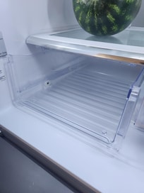 The front of this storage bin in the refrigerator was missing.