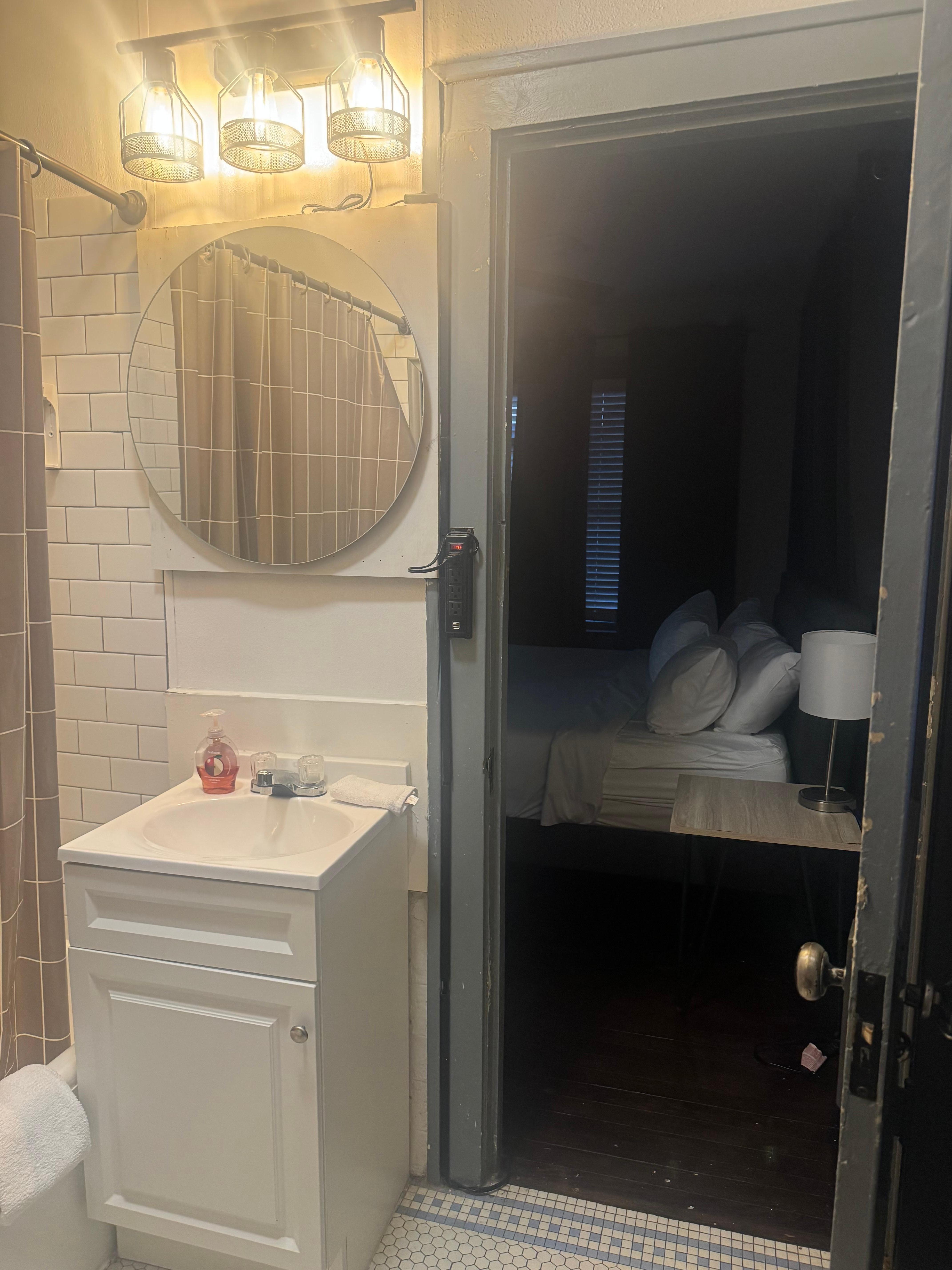 Power strip controls bathroom light, not a switch for code compliance