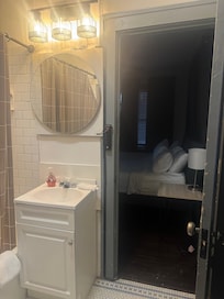 Power strip controls bathroom light, not a switch for code compliance