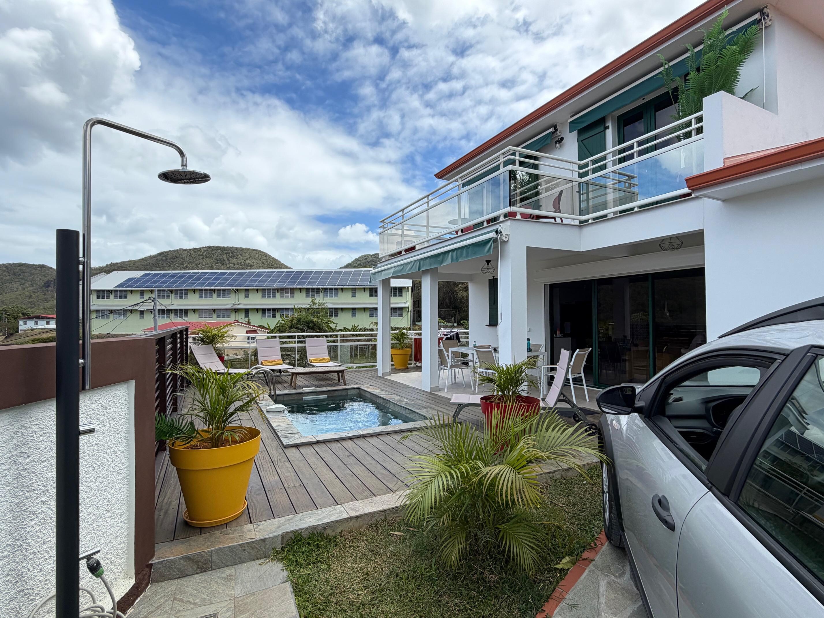 This view shows the house looking in from the front gate. Our rented car is parked on the paved drive-way.