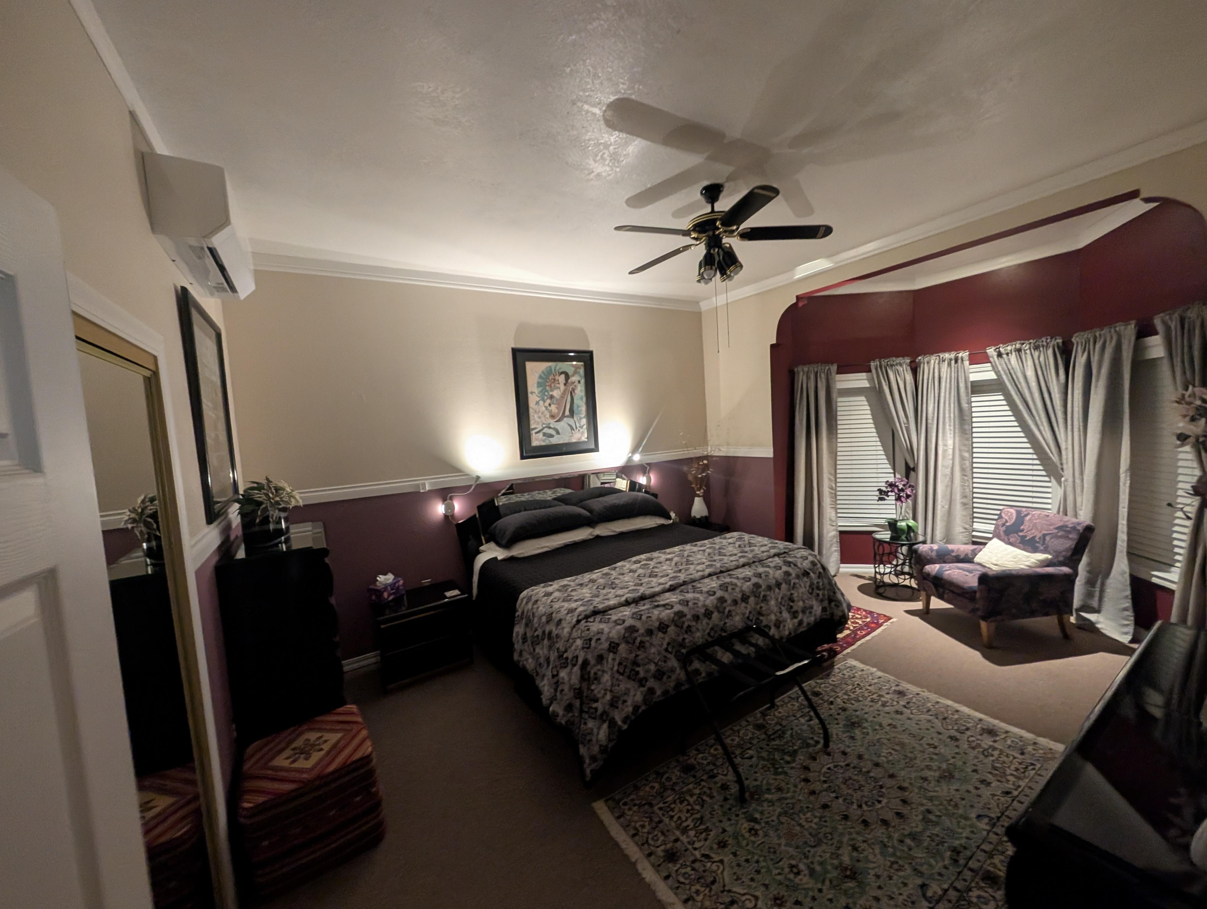 Upstairs bedroom with relaxing lighting and huge windows. 