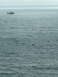 Helicopter Watching Over Boats Of Refugees.