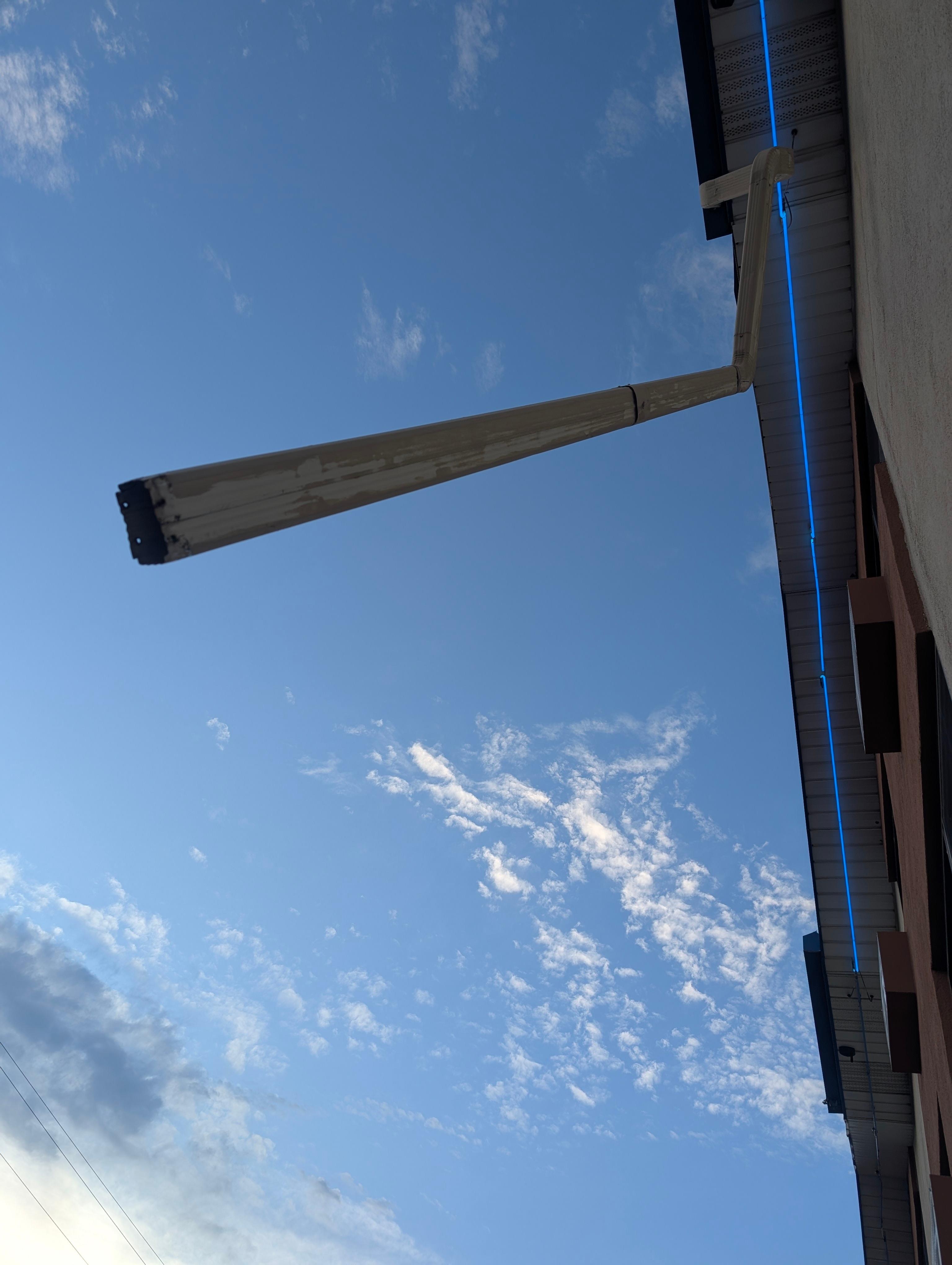 Downspout dangling above the door