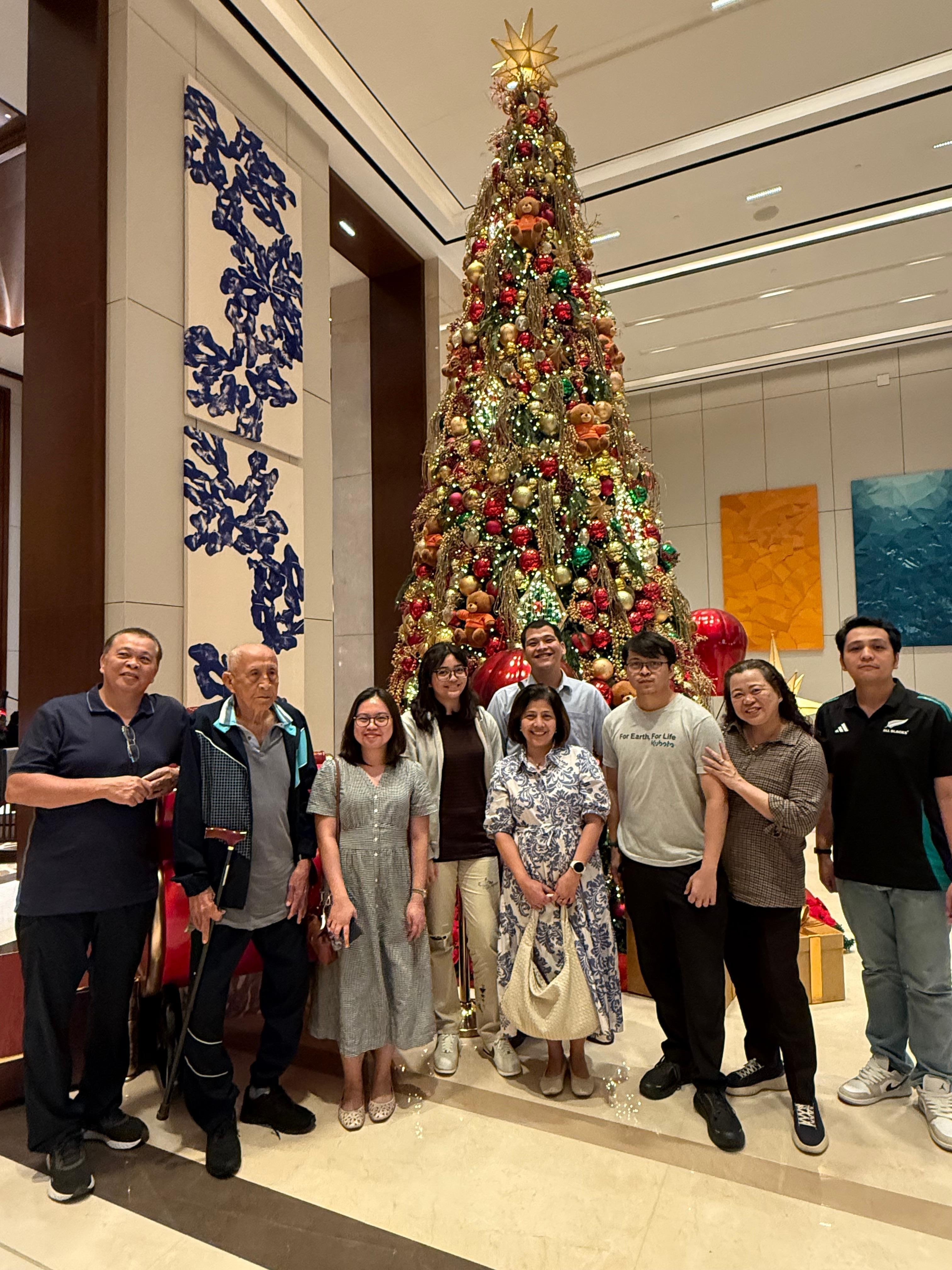 My family in the lobby Christmas tree