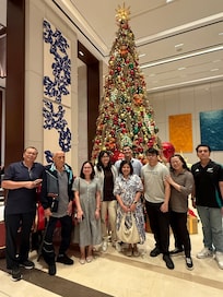 My family in the lobby Christmas tree