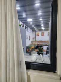 The window in my room was looking into so-called "dining room", which actually was enclosed back patio. No heat. Cold noisy area.
