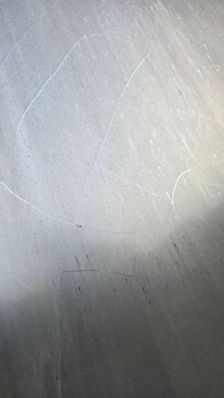 Window broken, only being held together by sunshade film.