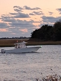 Deck of condo boat coming into marina.