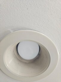 The ceiling is about 7 feet and I am 6'1 and my kid is 6'4. The first thing you see is a burnt out light with a bunch of dirt in it.
