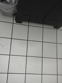 The bathroom floor tiles that are broken
