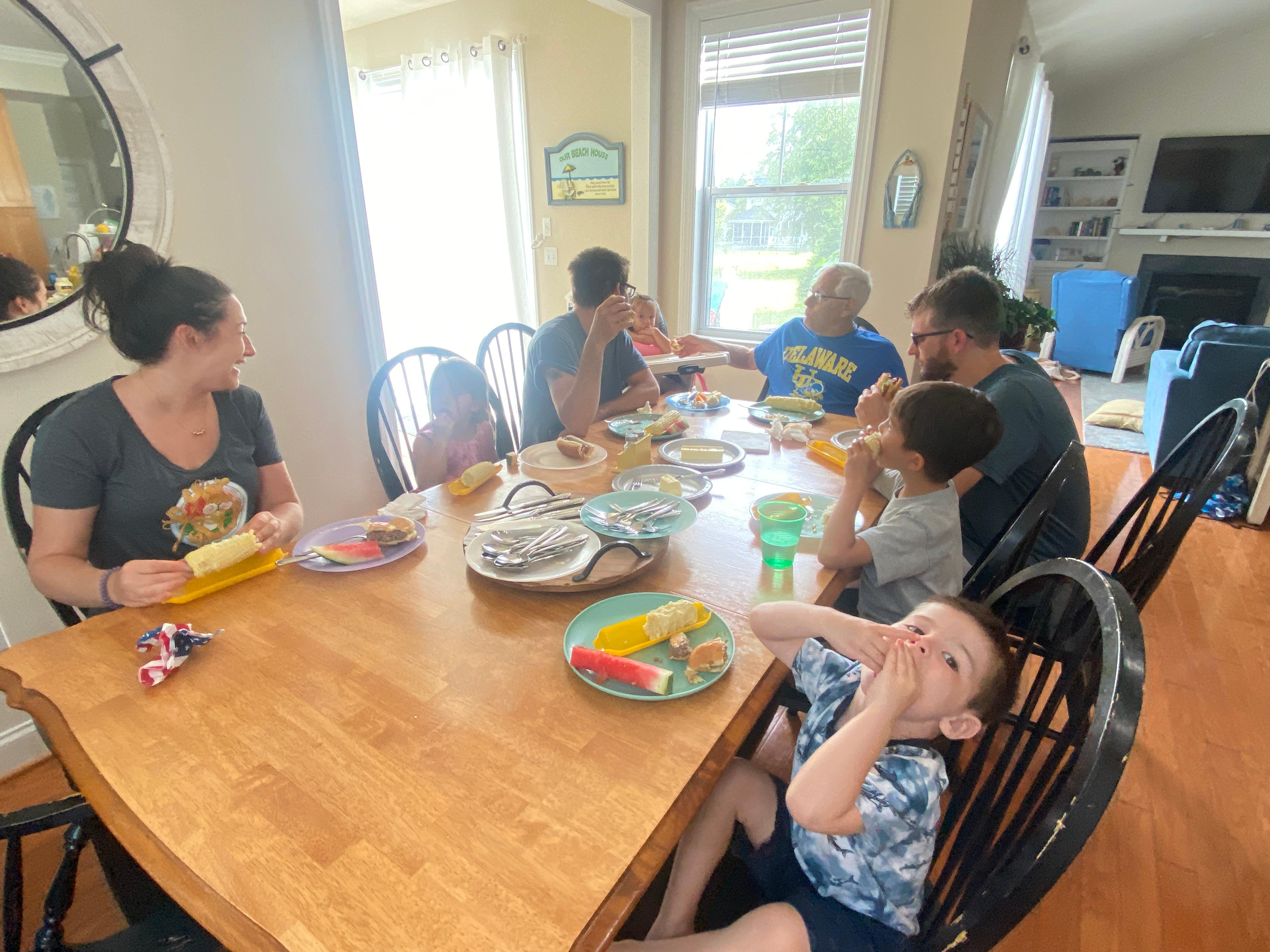 The kitchen table seats 8, the sunroom table seats 4, and there is a picnic table and table with umbrella and multiple chairs on the deck. 