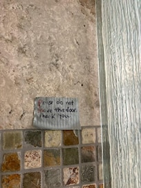note in shower about broken door
