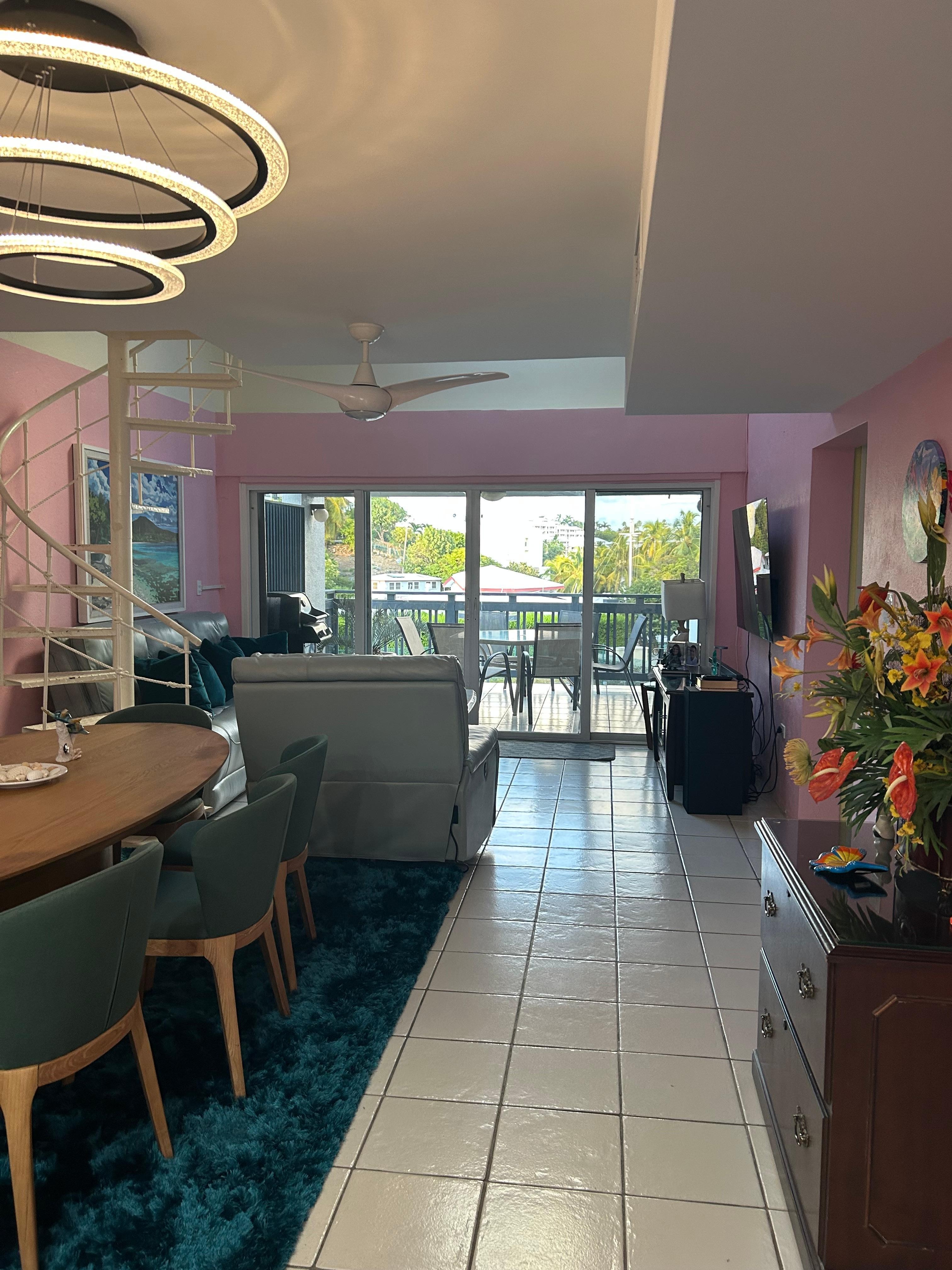 Large dining table and new leather couches in the living room. 