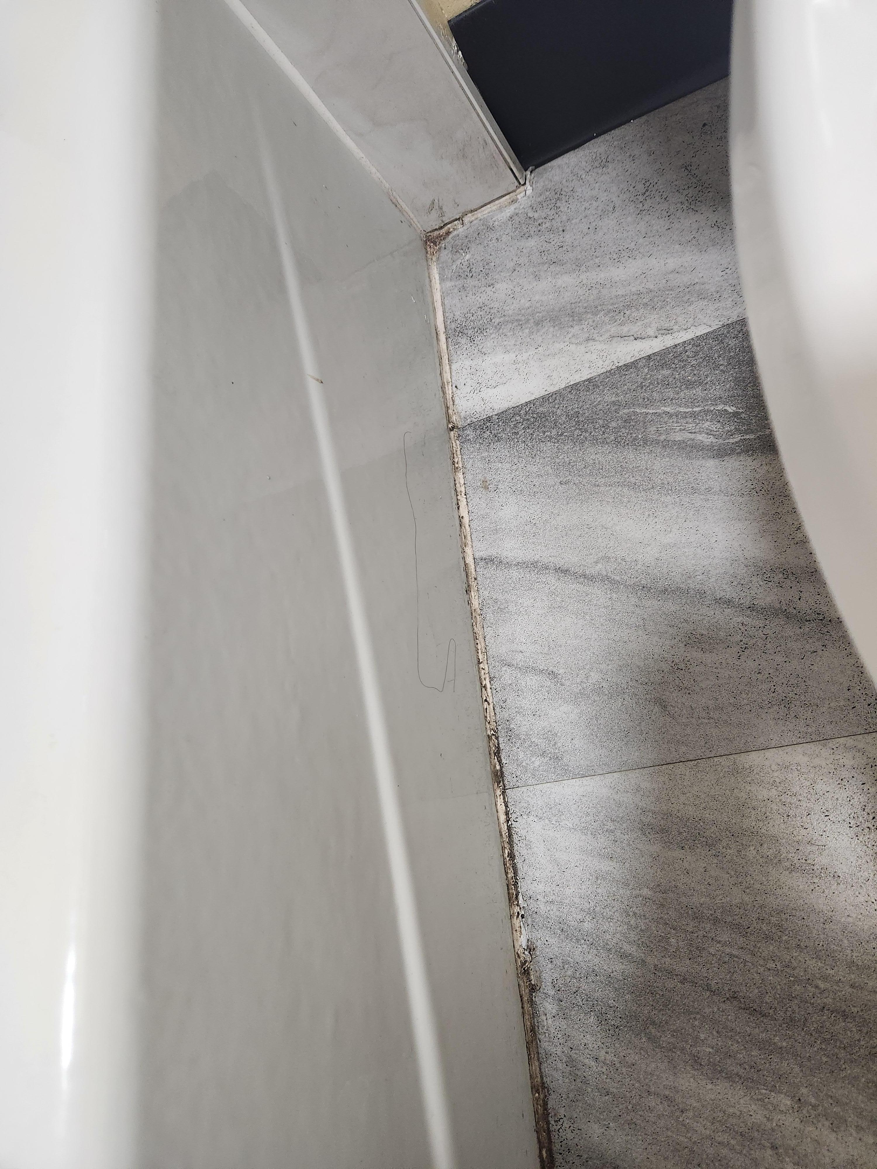 Dirty and moldy bathroom  floors. 
