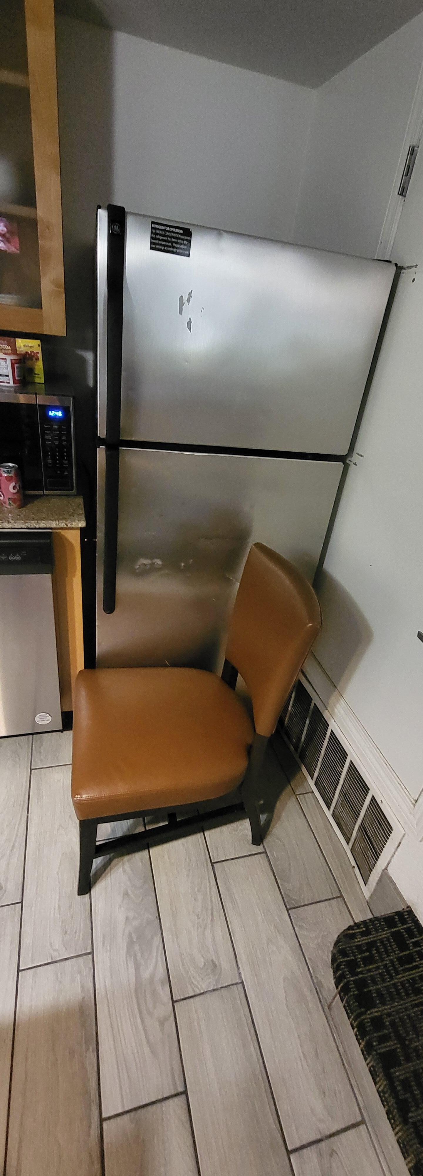 Dented non working refrigerator. 