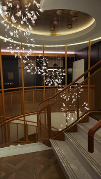 Stairway leads to lower floor with a bar lounge, library gym, and toilets.