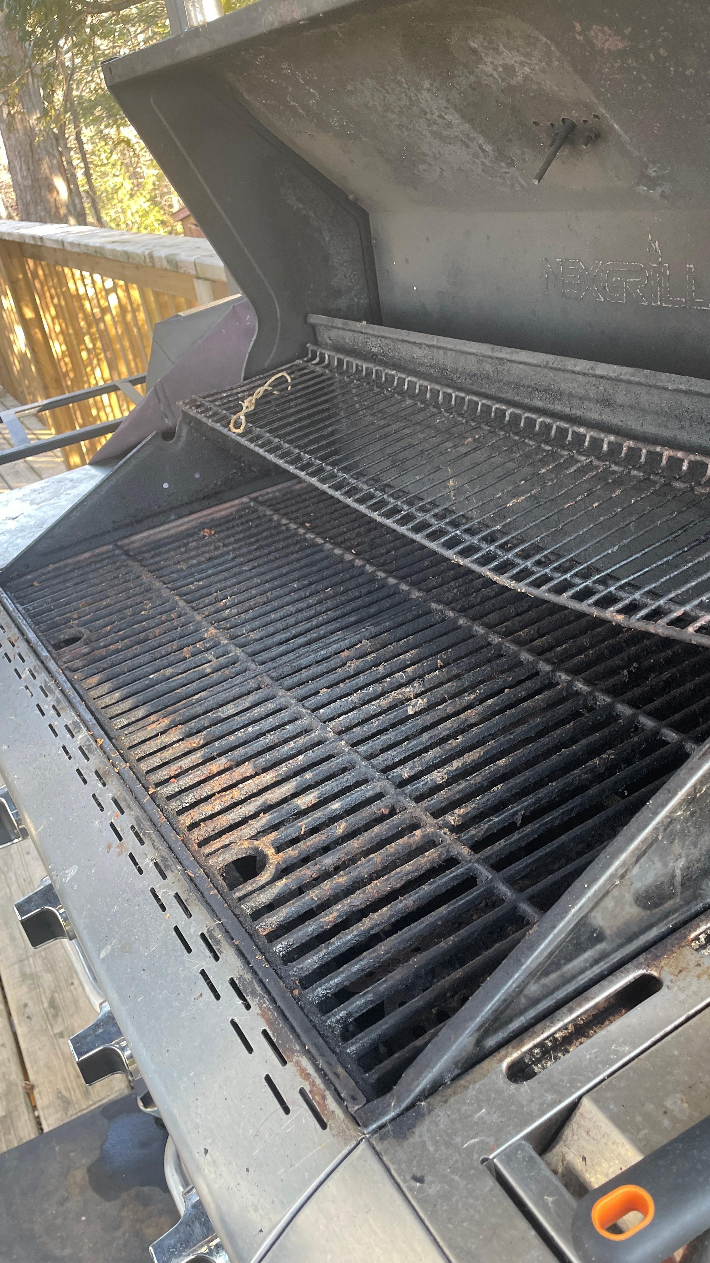 grill covered in food residue and grease.
