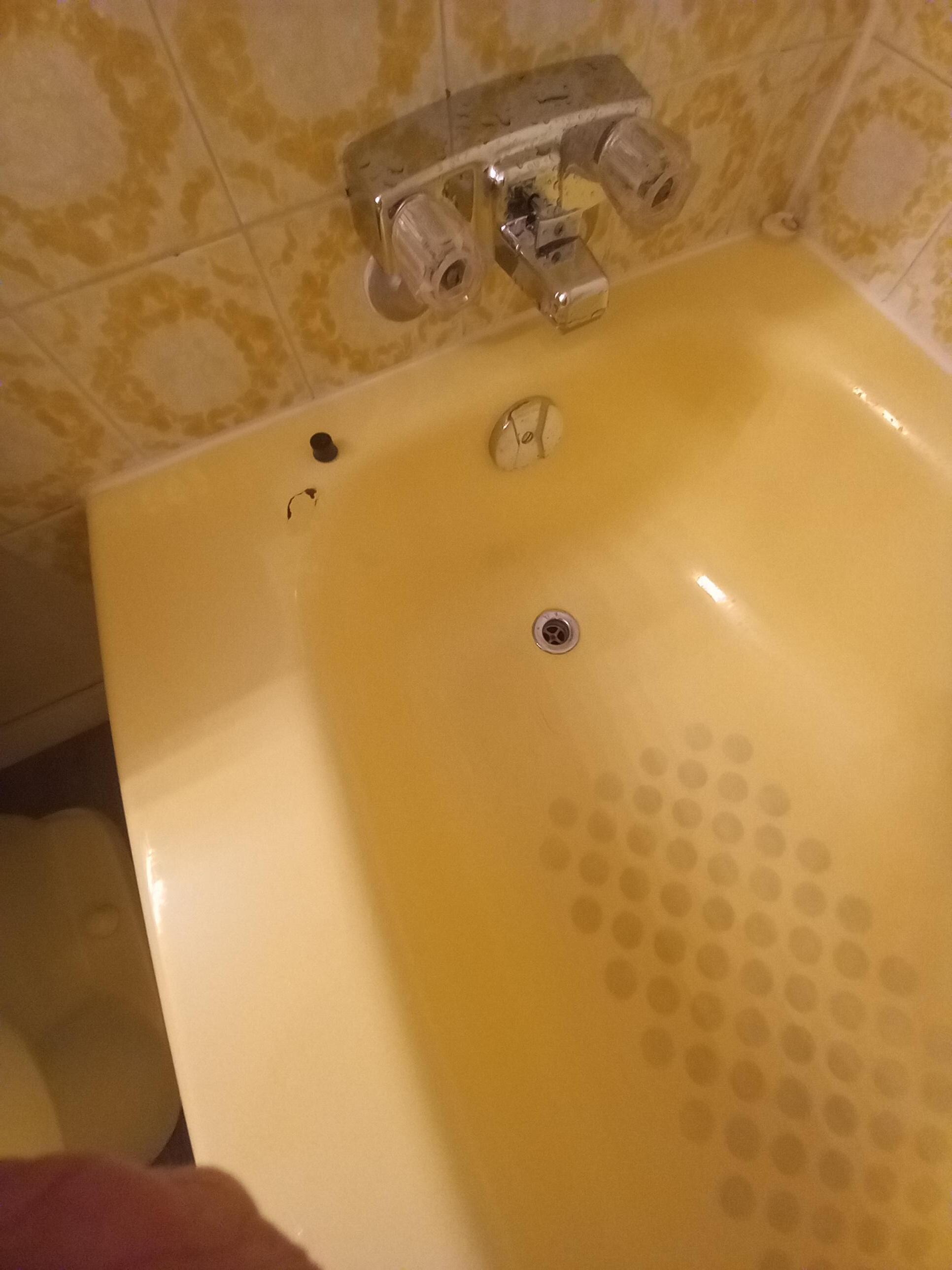 Tub has been repaired poorly, looks dirty & is stained