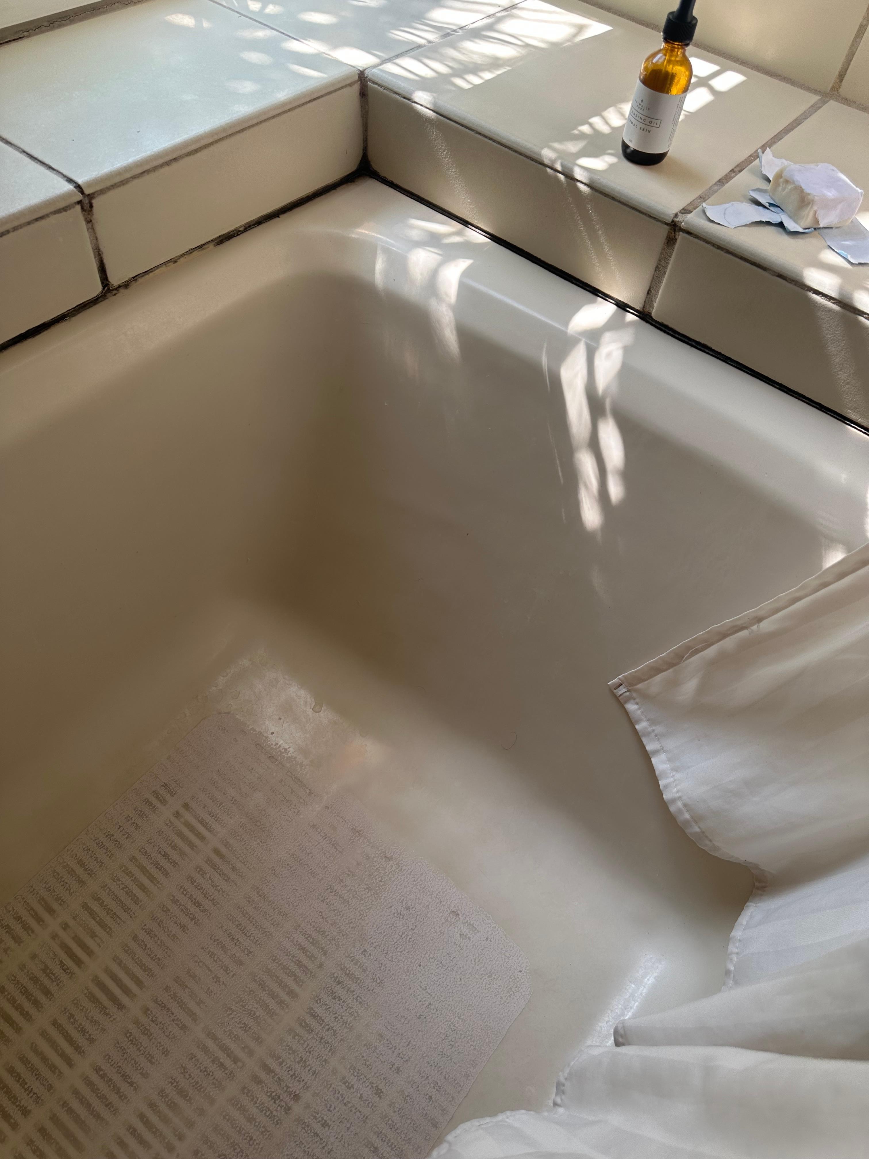 Many bits of grout in this tub are missing; likely mold growth behind the tile/tub.  Tub is stained and much of the light colored grout is again dirty and seems moldy/mildew stained