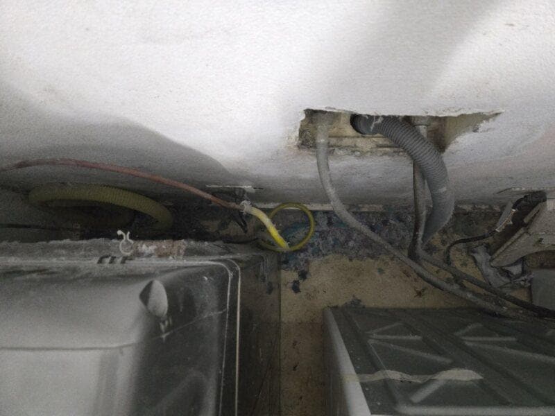 Dryer not connected to vent properly. Extremely dirty behind the dryer