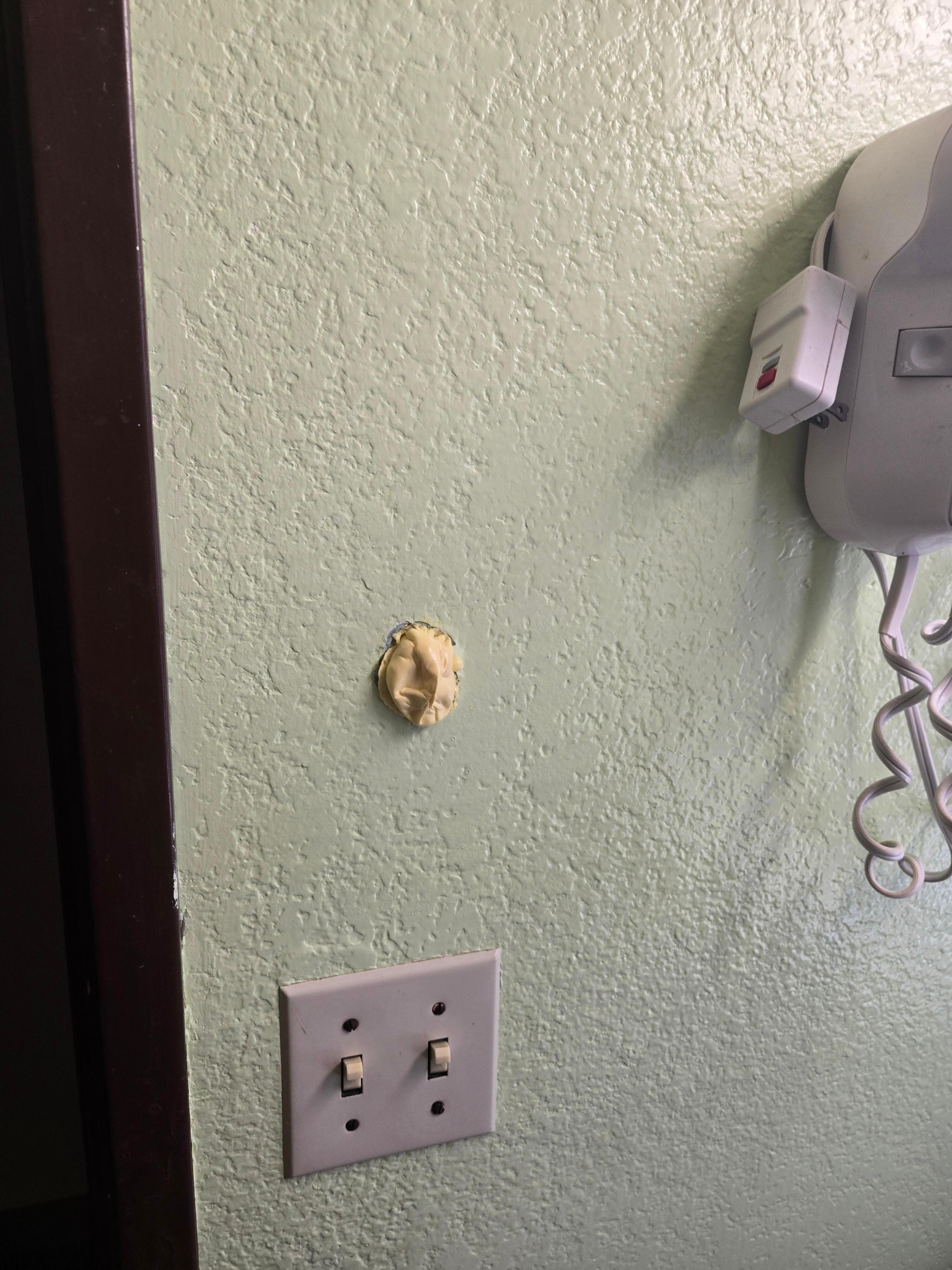 Hole in bathroom wall