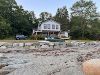 A view from the shoreline looking back at the cottage.