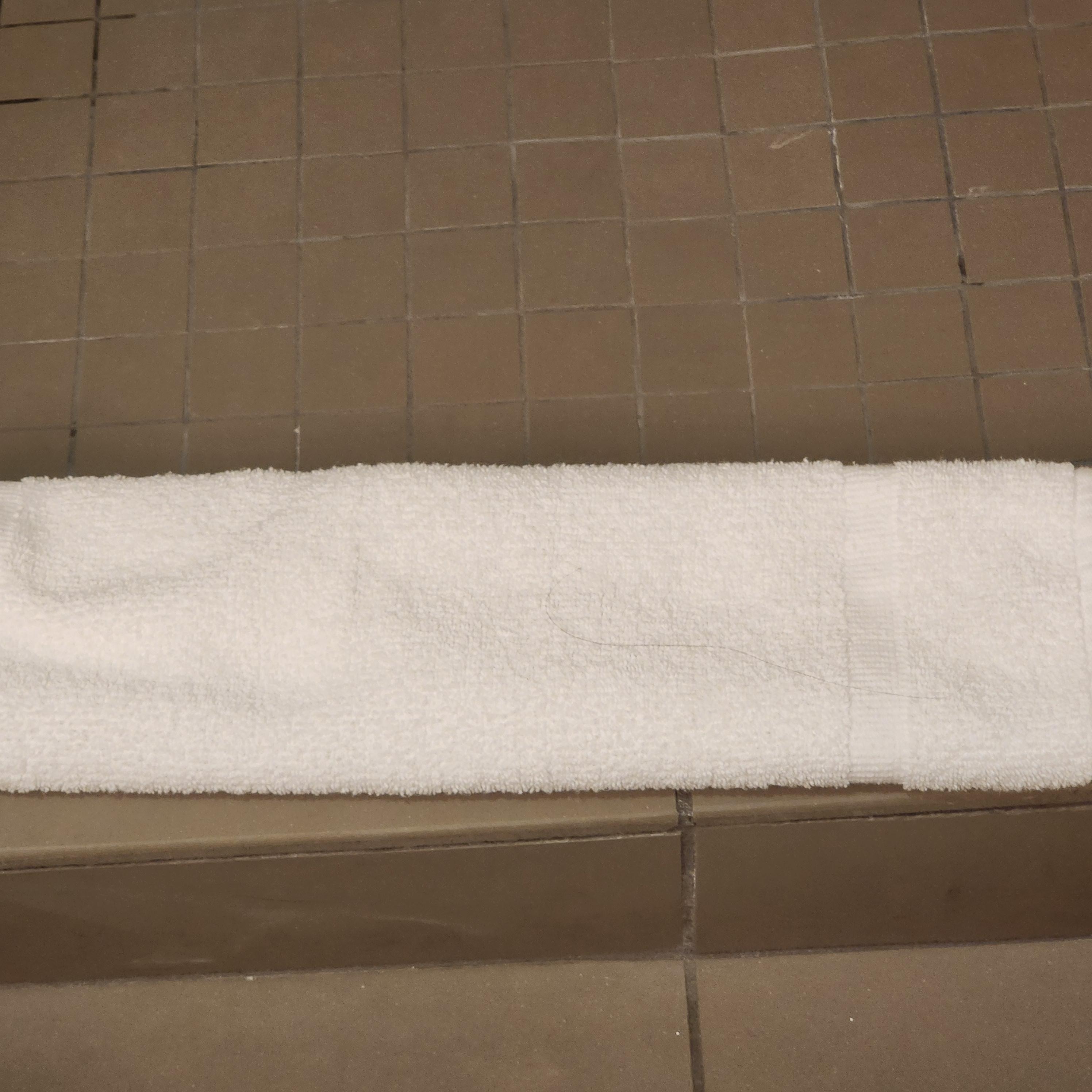 Large hair on shower floor towel