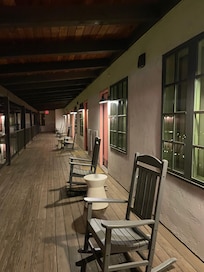 Outside of the rooms are rocking chairs