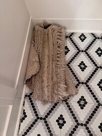 Rolled up rug due to dirt