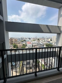 Looking outside from the hallway balcony from the 10th floor on a hot summer morning.