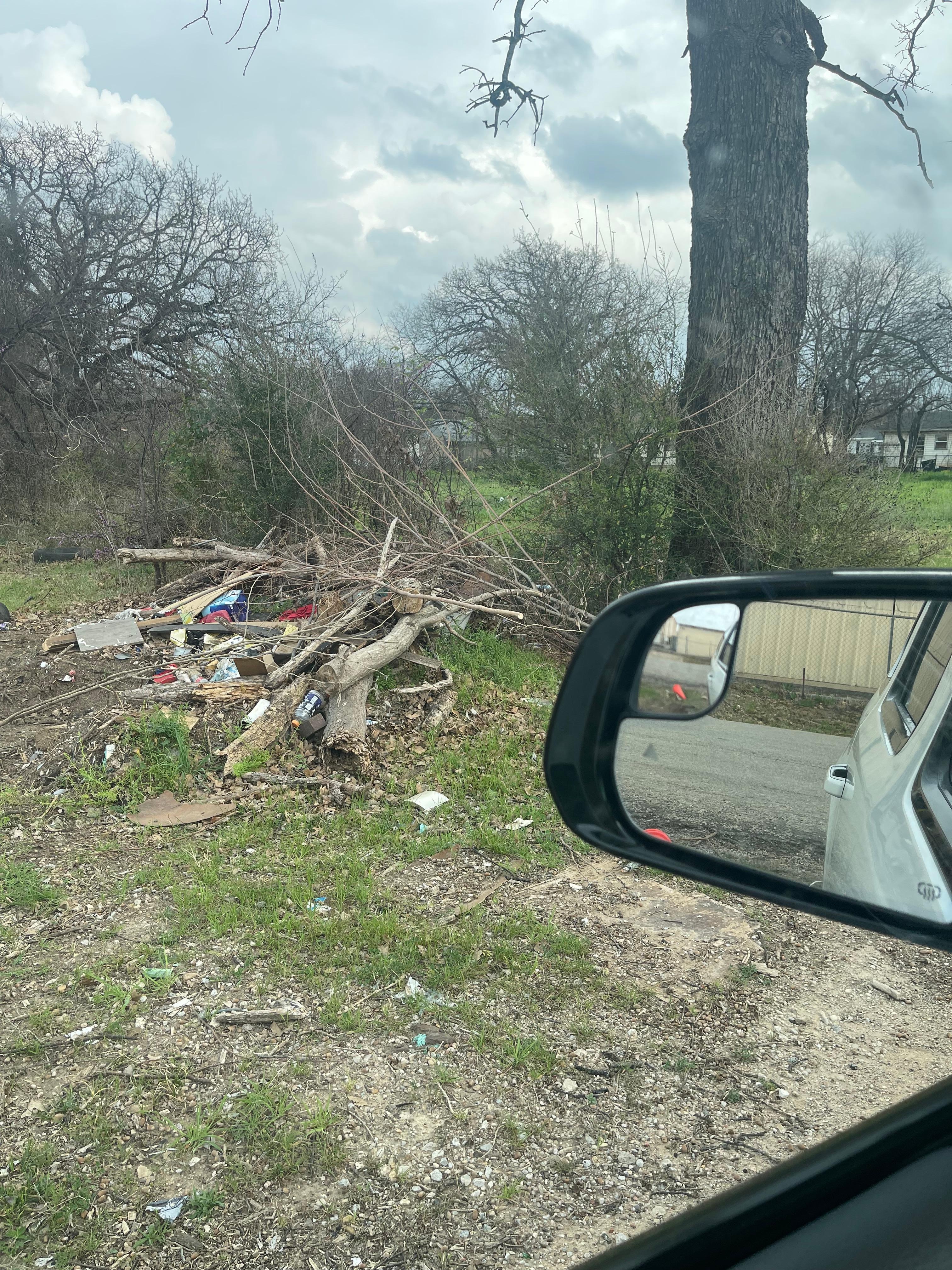 Trash with drug paraphernalia in driveway and not mowed
