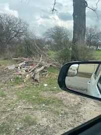 Trash with drug paraphernalia in driveway and not mowed
