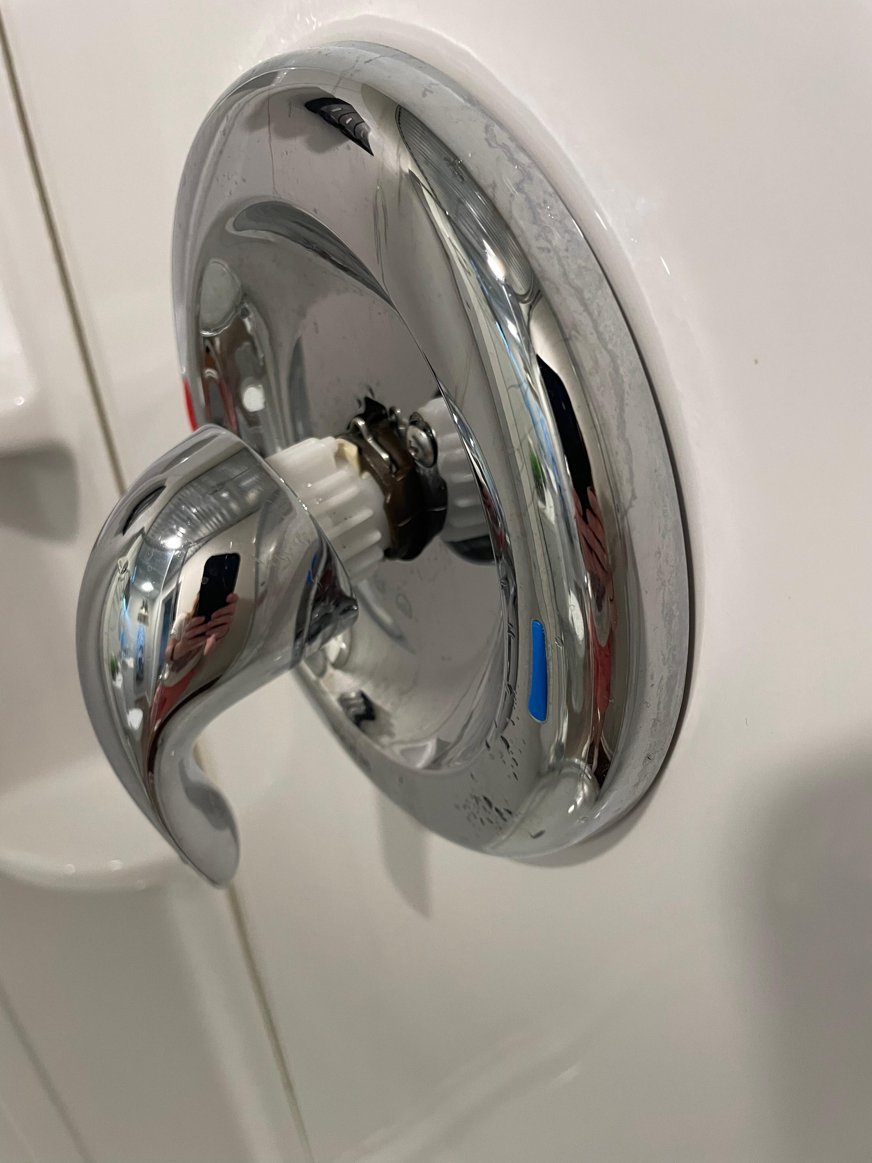 The shower handle was pulling out of the shower.