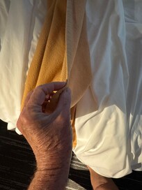 Paper thin blanket with sheet is all that was on bed.