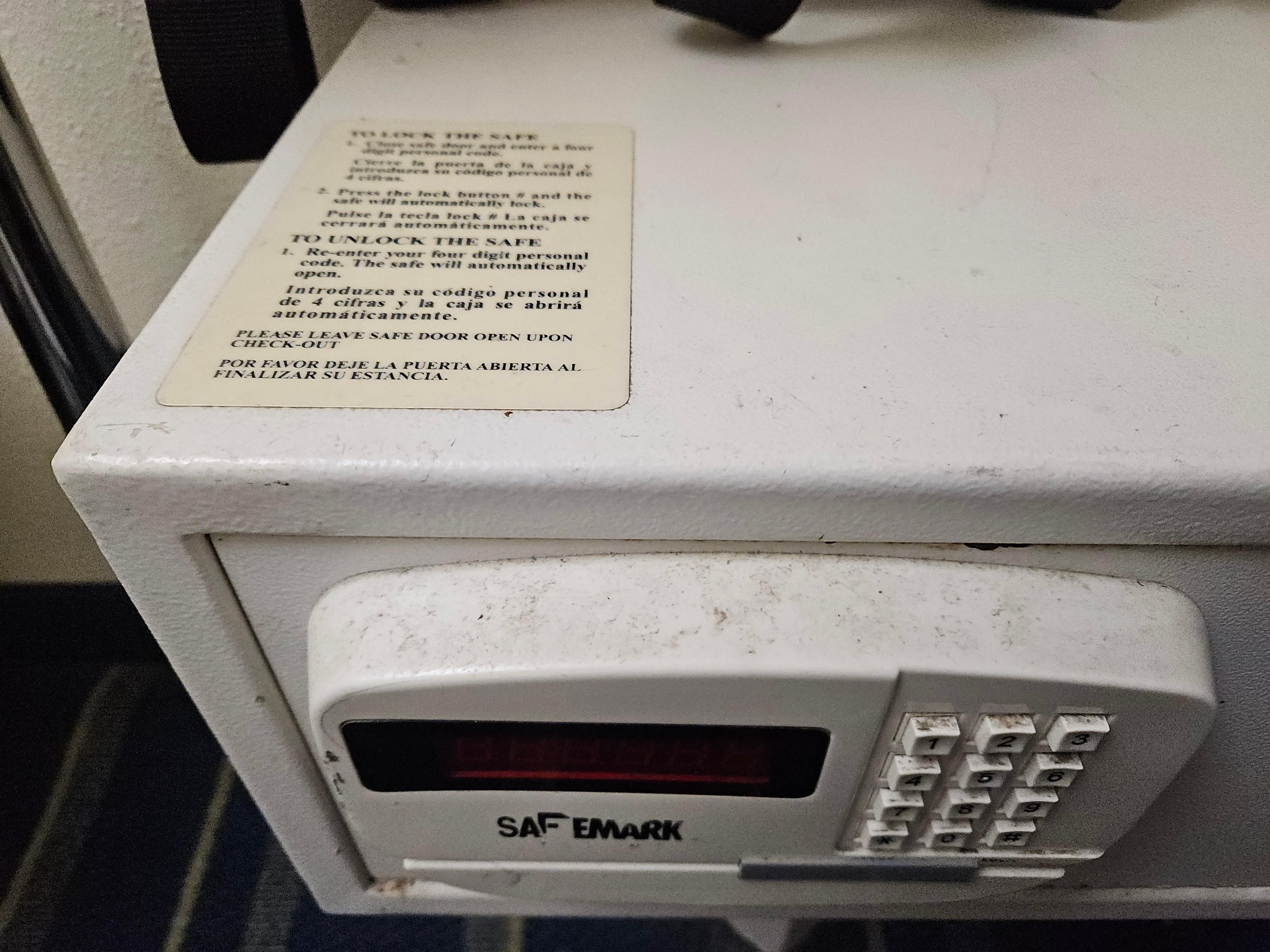 Dust/dirt on the front of the safe in the room.