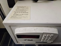 Dust/dirt on the front of the safe in the room.